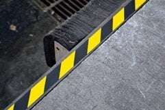 A loading doc marked with floor marking caution tape.