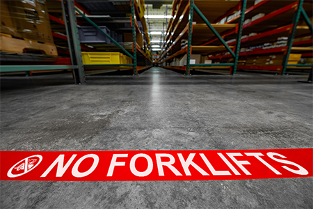Warehouse floor marked with messaged floor marking tape
