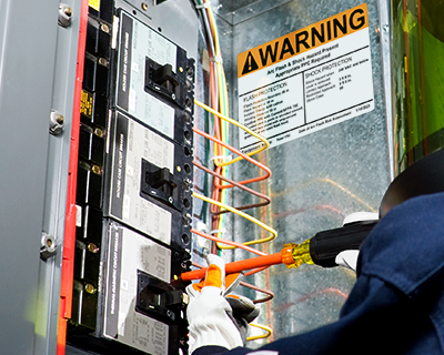 Arc flash industrial safety label on an electrical panel.