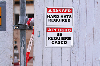 A danger sign displayed with both English and Spanish messages
