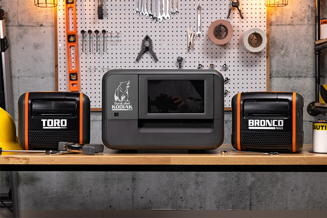 DuraLabel Toro Max Kodiak Max and Bronco Max Industrial Label Printers displayed on a workbench