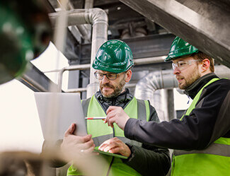 Workers examine inspection checklist