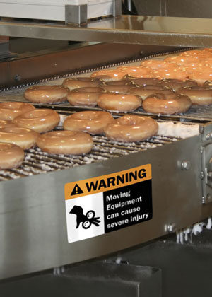 OSHA sign warns of conveyor pinch point.