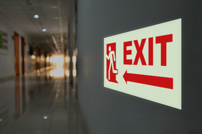 Red and white exit sign in hallway