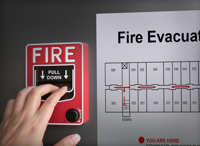 Fire alarm next to a fire evacuation sign