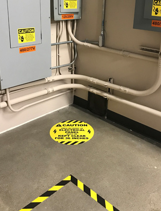 Floor signs and tape highlight control panels